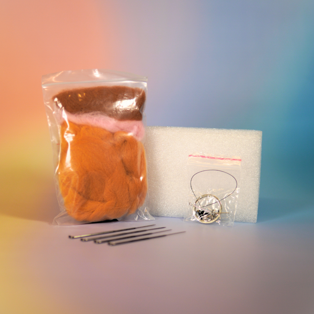 Creatief naaldvilten pakket voor oranje kat decoratie